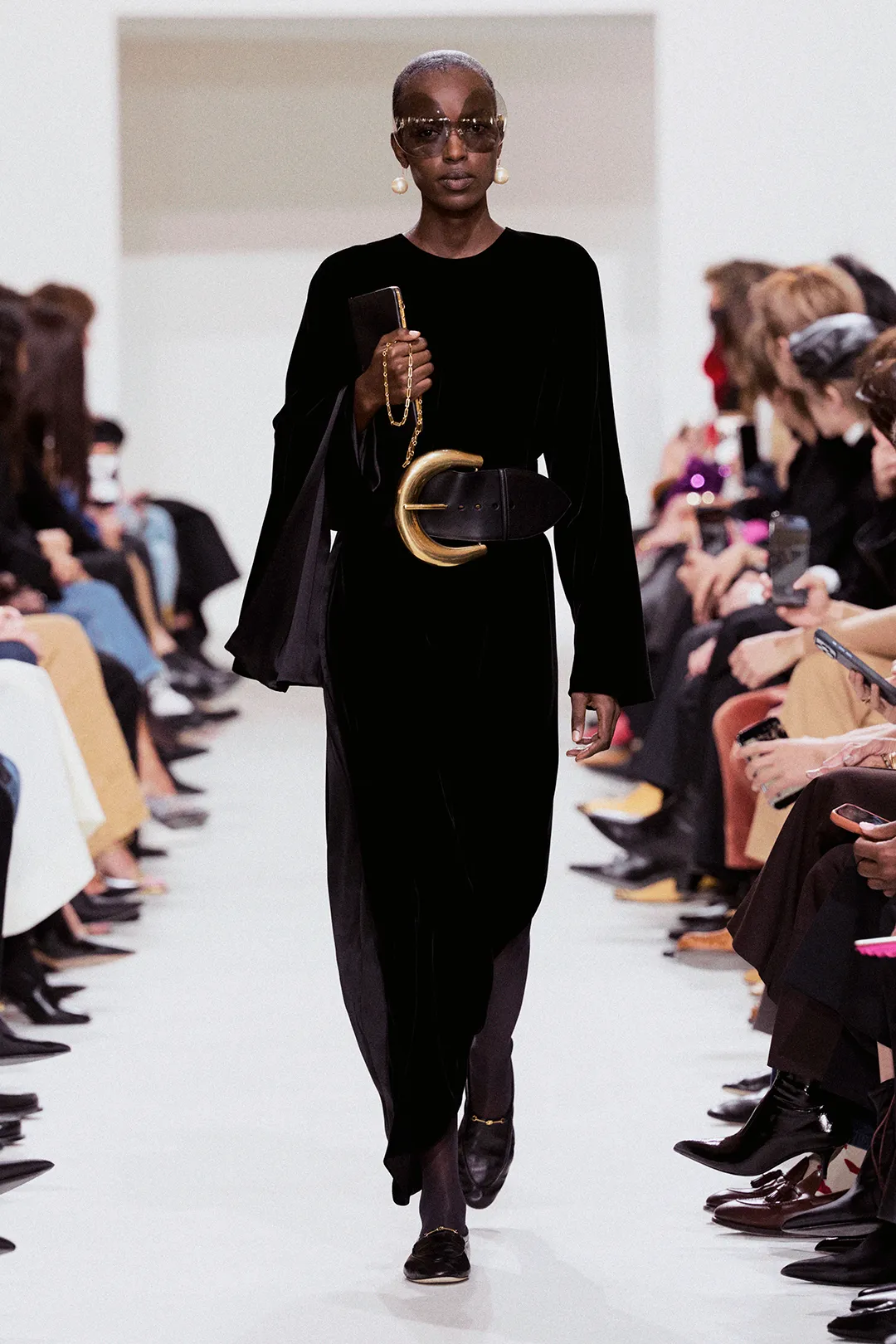 Image may contain Adult Person Electronics Mobile Phone Phone Fashion Clothing Coat Long Sleeve and Sleeve