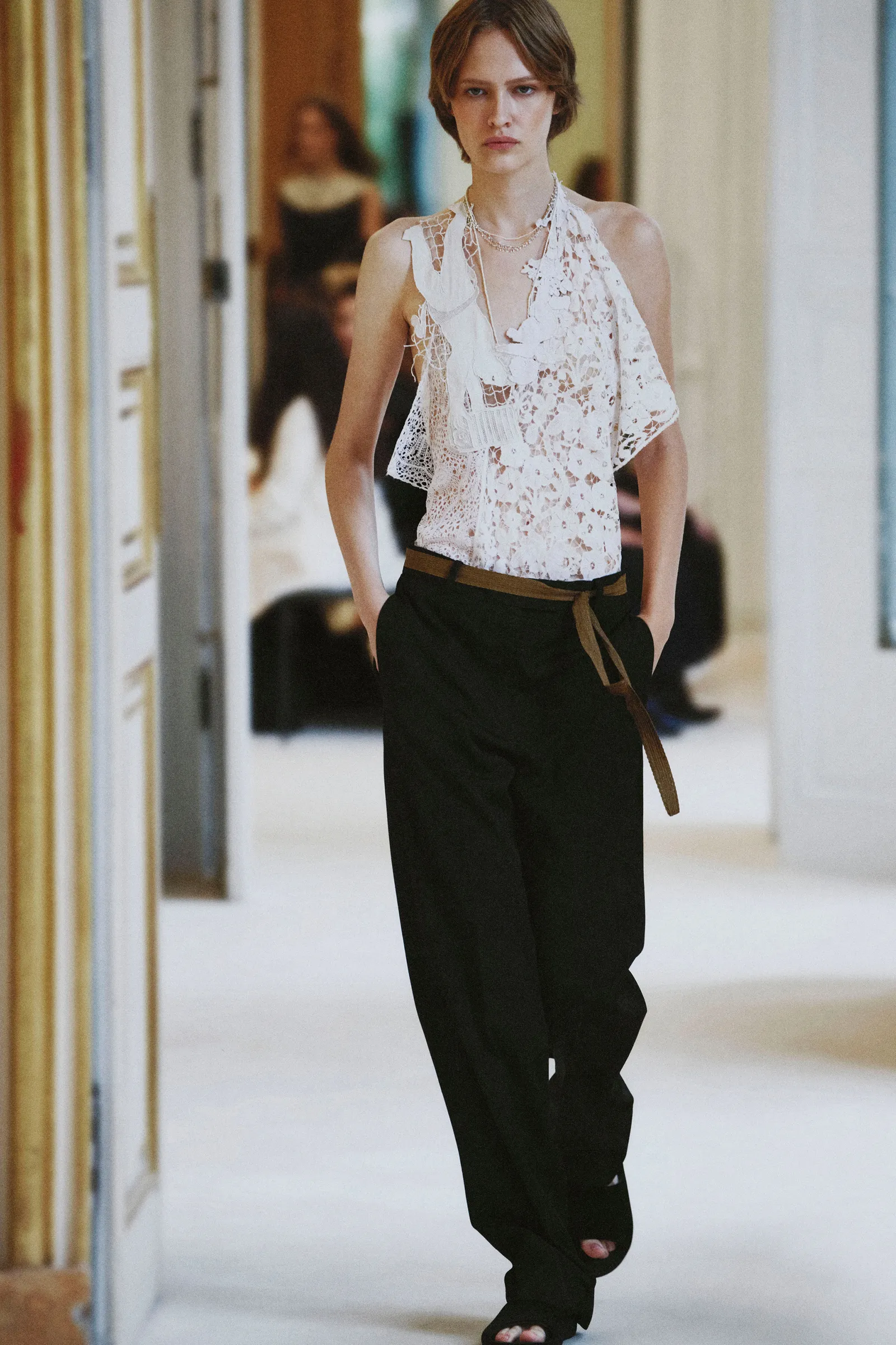 Image may contain Clothing Pants Blouse Adult Person Sleeve and Formal Wear