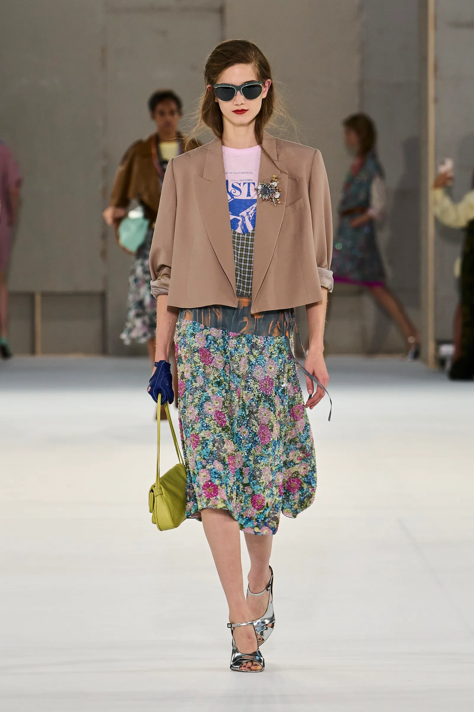 Image may contain Manuela Bosco Clothing Skirt Accessories Bag Handbag Blazer Coat Jacket Adult and Person