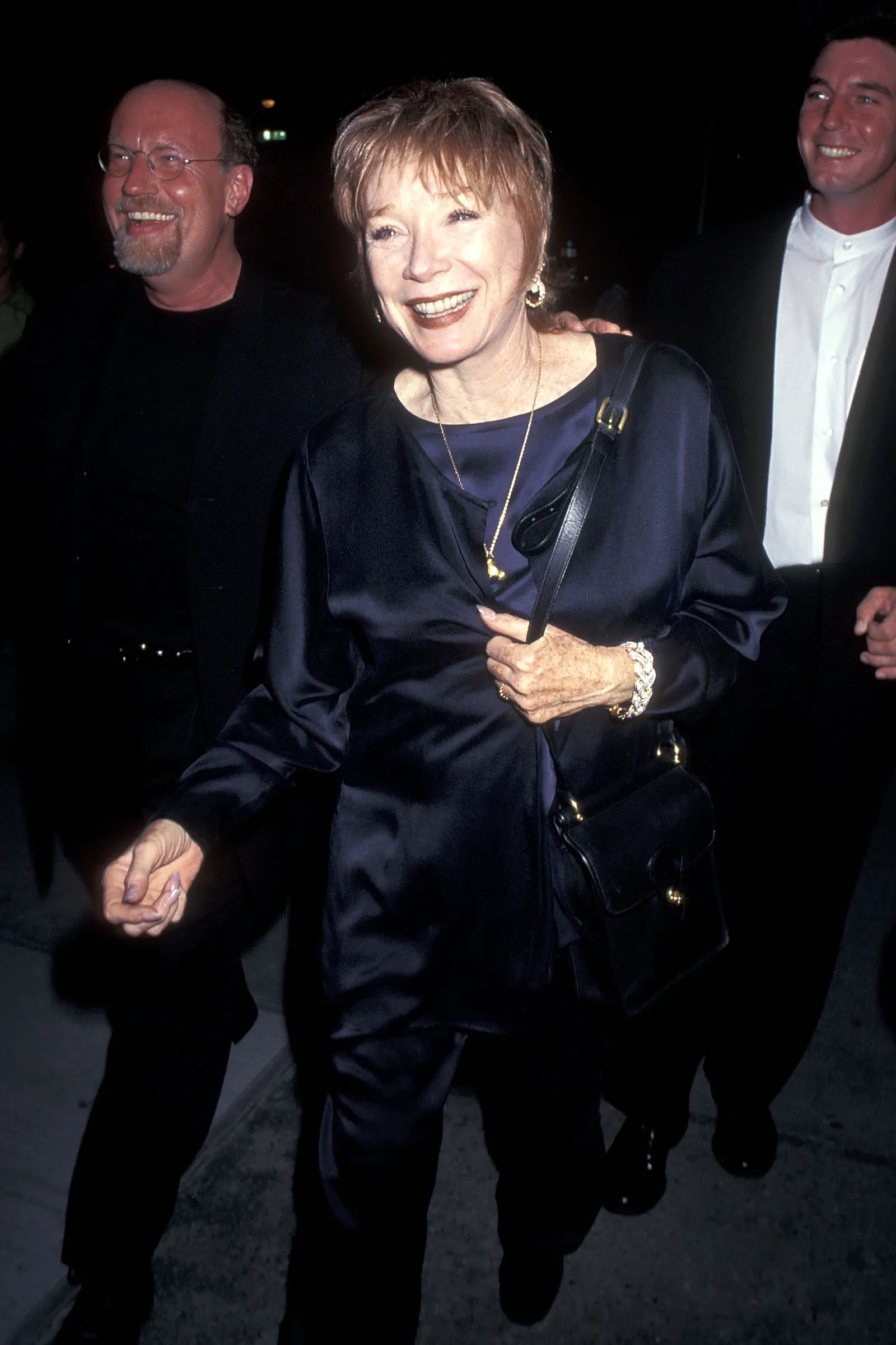 Image may contain Shirley MacLaine Blazer Clothing Coat Jacket Accessories Bag Handbag Jewelry Necklace and Face