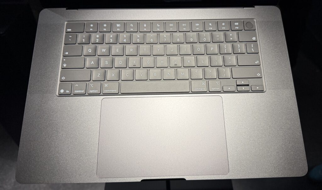 A standard Apple laptop keyboard and trackpad