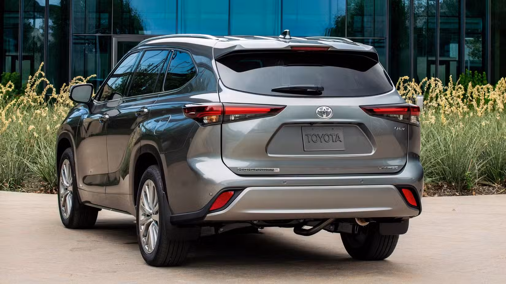 2026 Toyota Highlander Hybrid Rear 3/4 shot parked in driveway