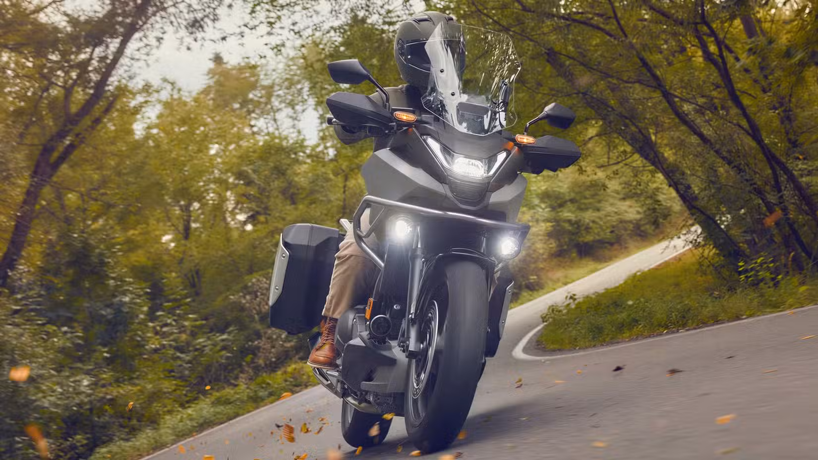 2026 Honda NC750X leaning into a corner front third quarter view