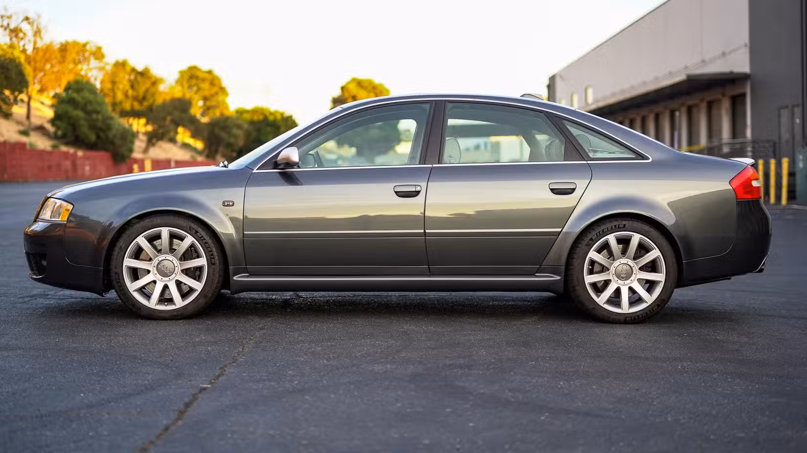 The side profile view of a grey 2003 Audi RS6 Sedan parked