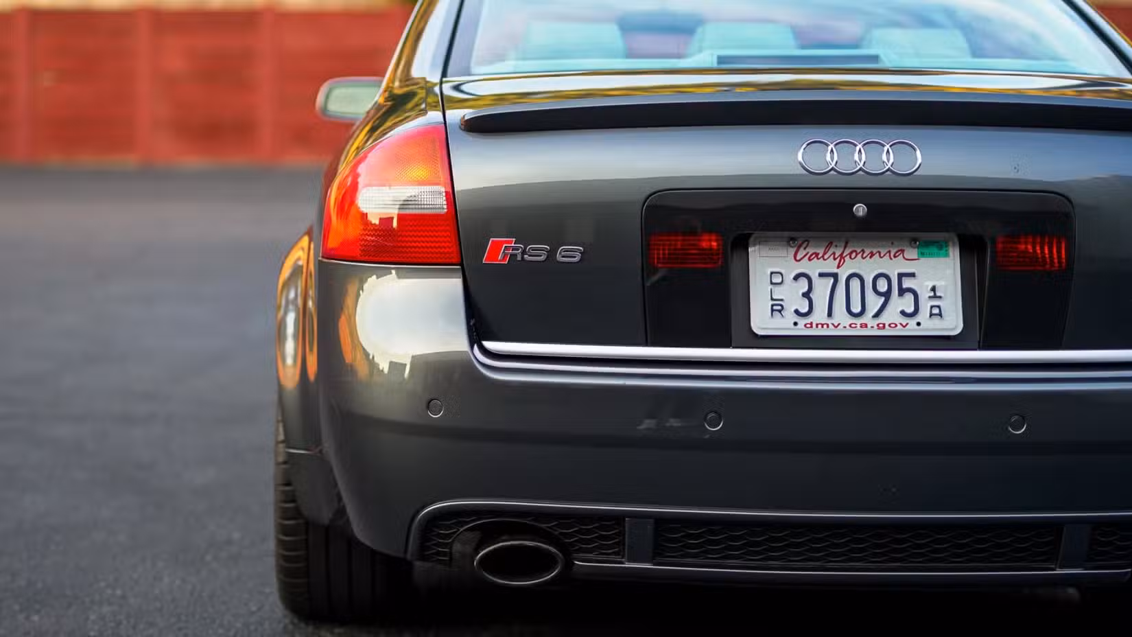 A rear-end close-up shot of a grey 2003 Audi RS6 Sedan