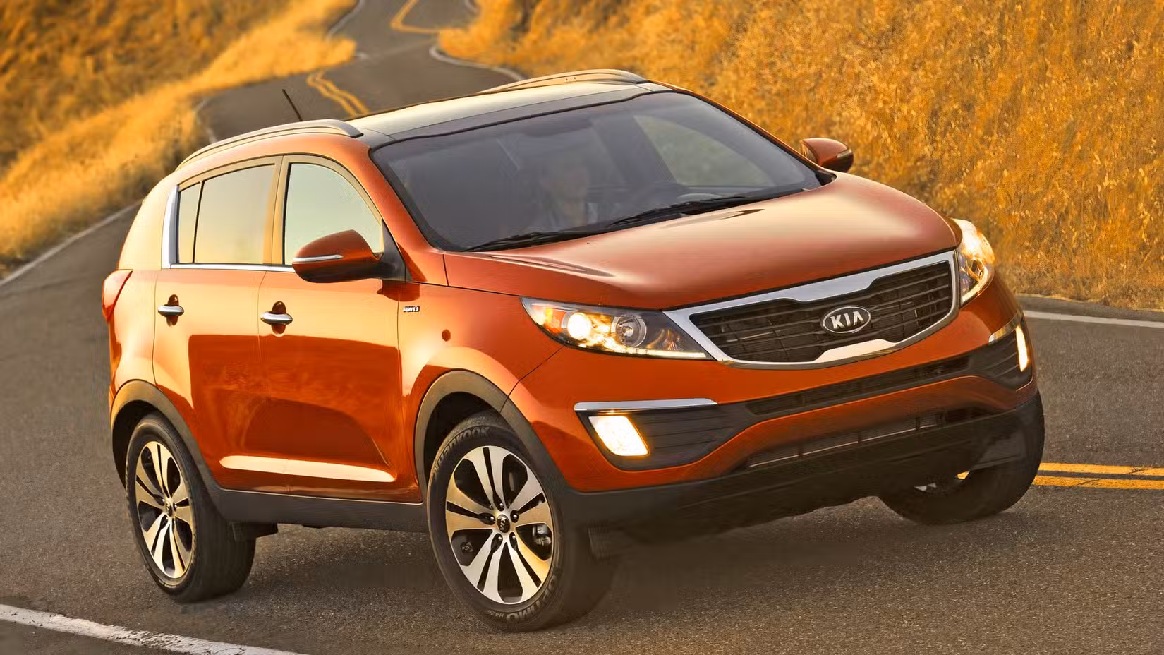 Red 2011 Kia Sportage Action Shot driving 