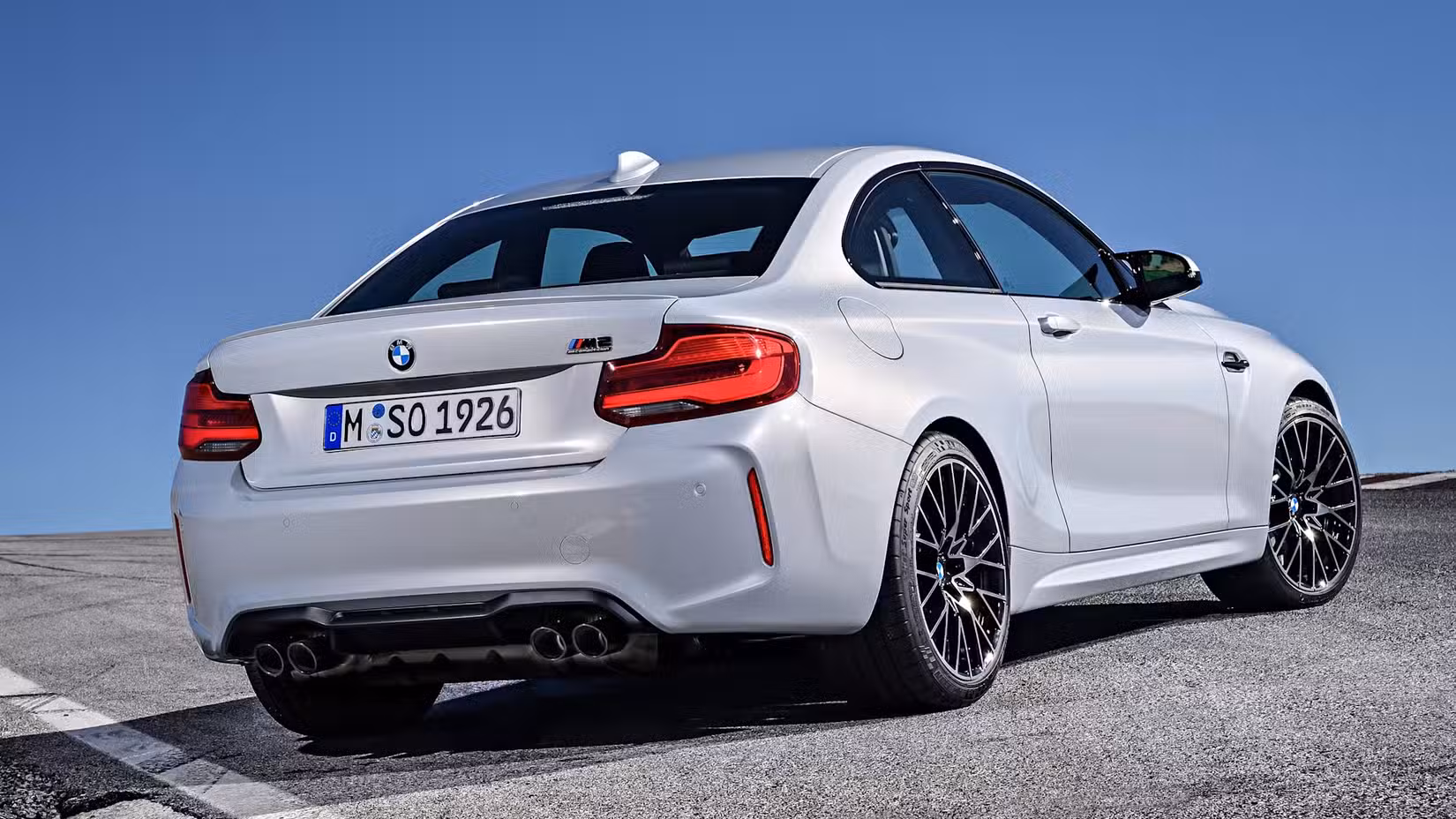 A rear end shot of a Silver 2018 BMW M2 Competition