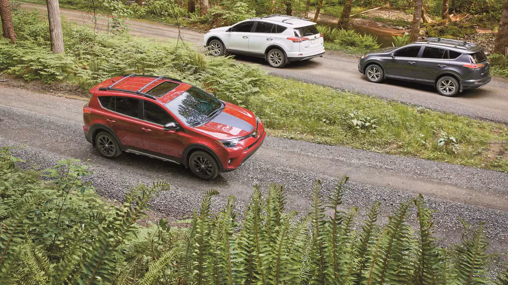 2018 Toyota RAV4 far front shot driving on dirt road