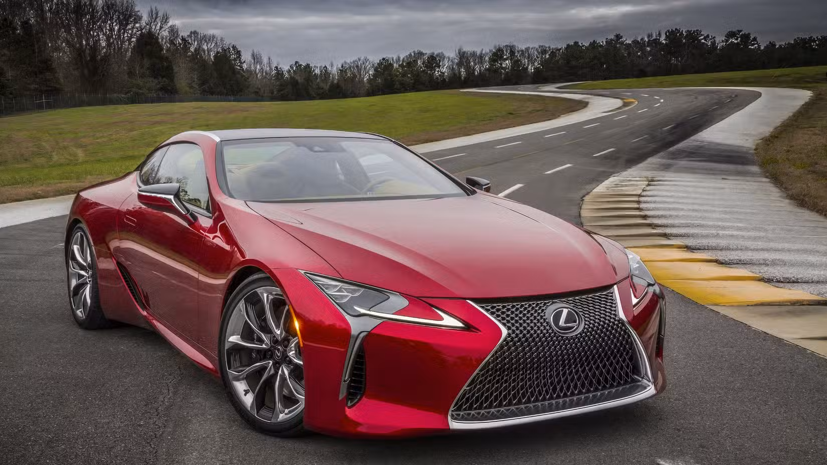 Front 3/4 shot of a red 2019 Lexus LC 500 being driven on a race track