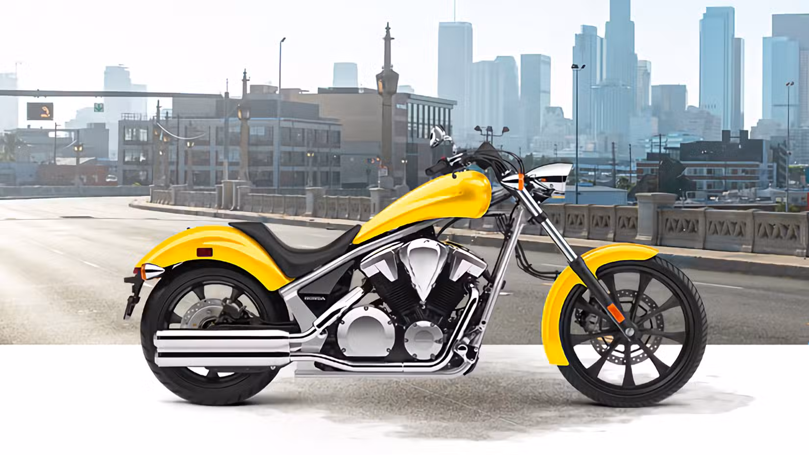 Yellow 2022 Honda Fury static profile shot of right side in front of a cityscape
