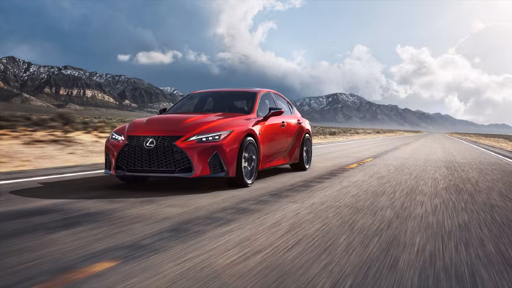 Fornt 3/4 shot of a 2023 Lexus IS500 accelerating on desert road