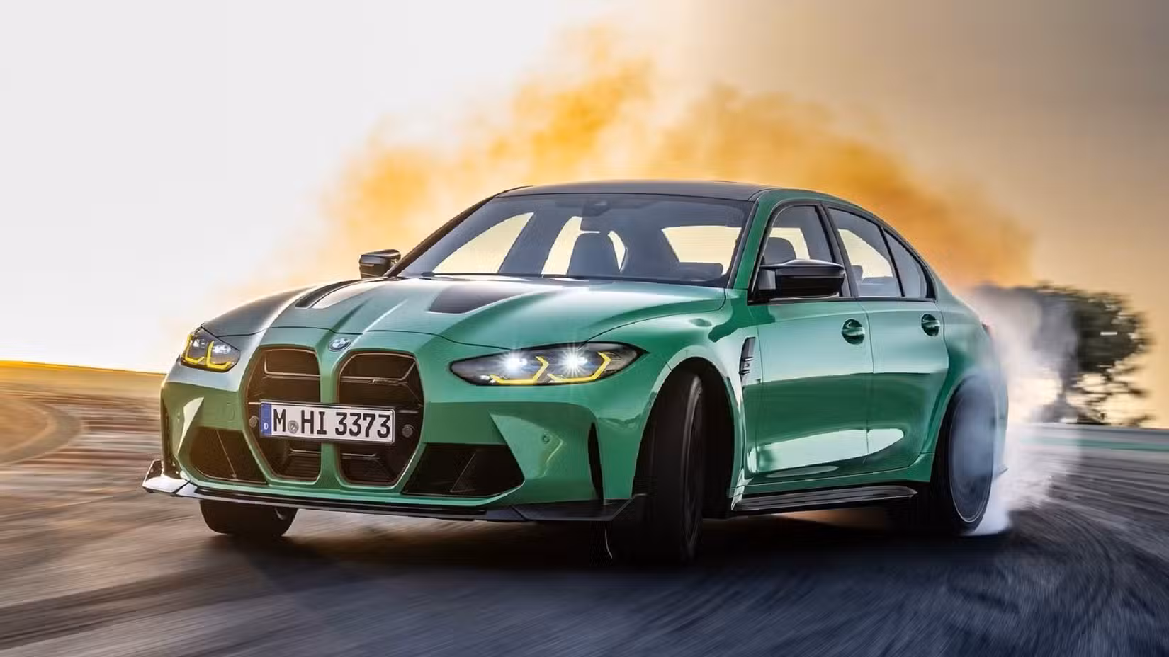 A moving 2024 BMW M3 laying some rubber