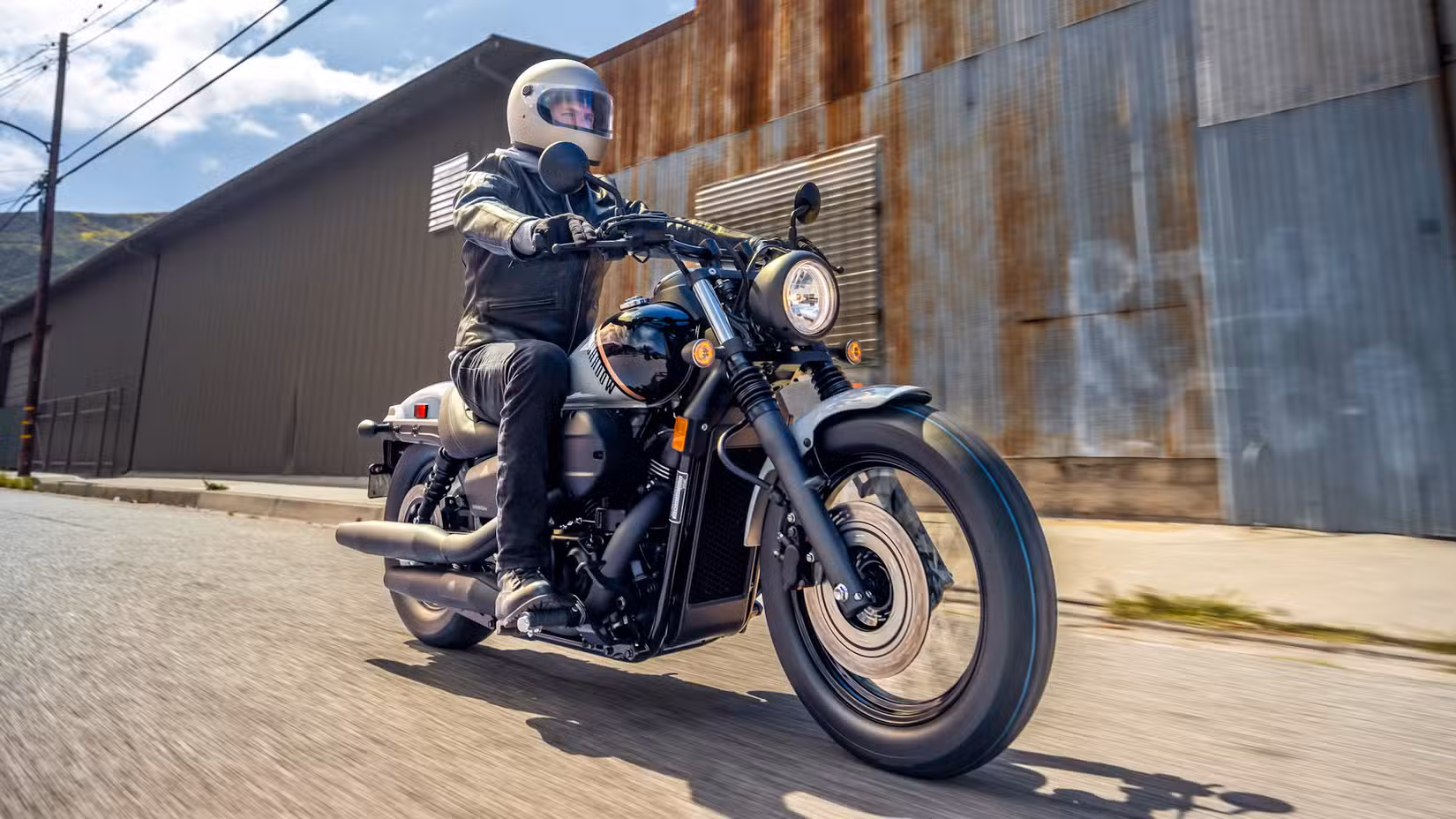 Honda Shadow Phantom cruising through an industrial area
