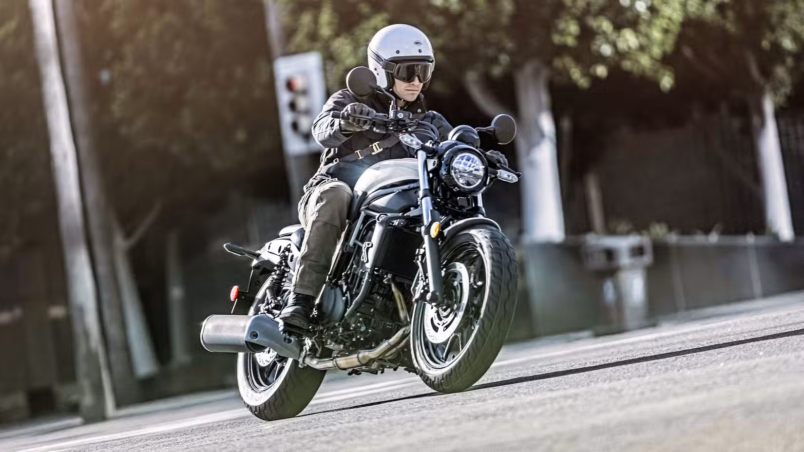 White 2024 Kawasaki Eliminator 450 cruising through town