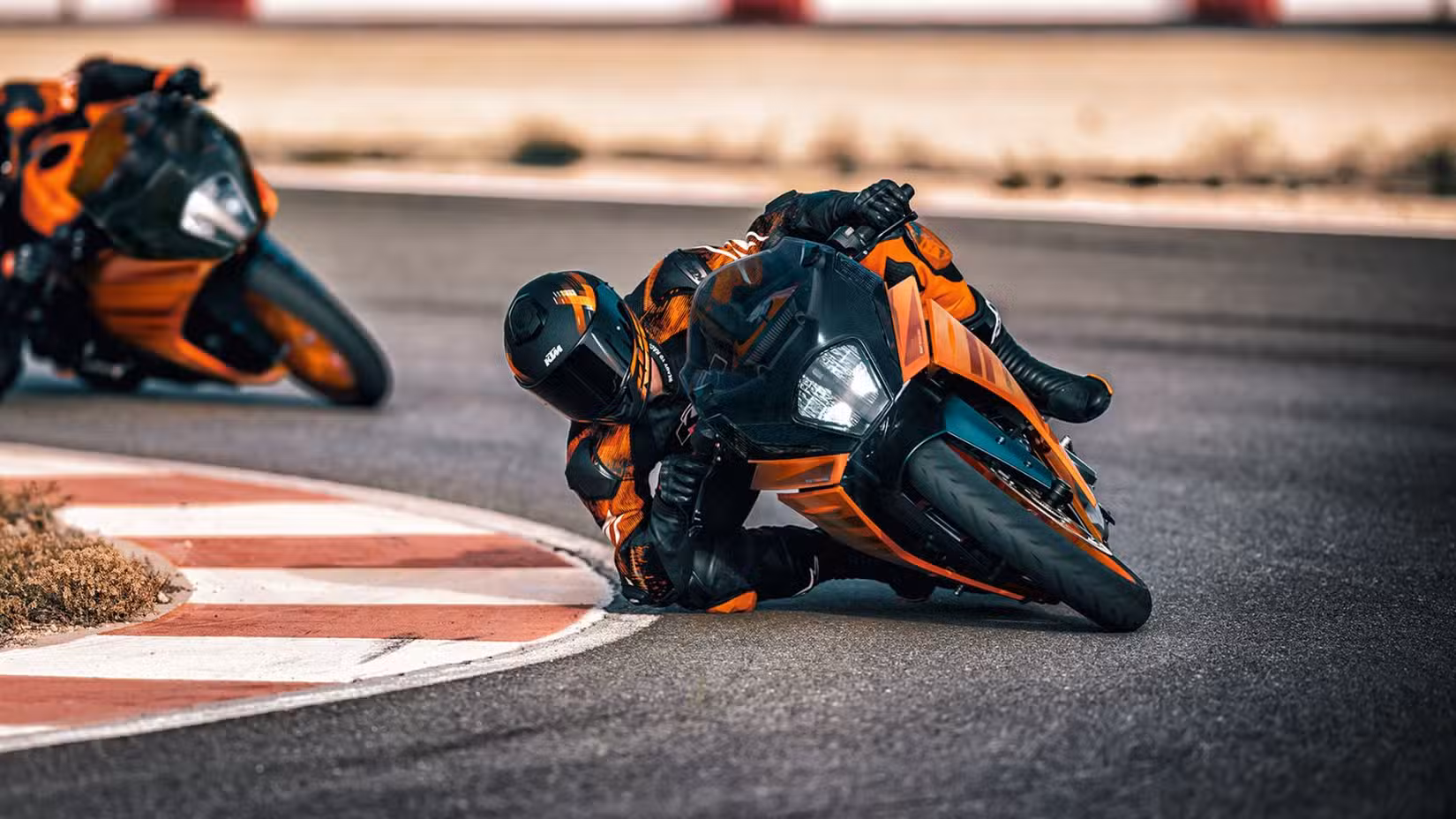 Action shot of KTM RC 390 supersport leaning down a corner on the racetrack. 