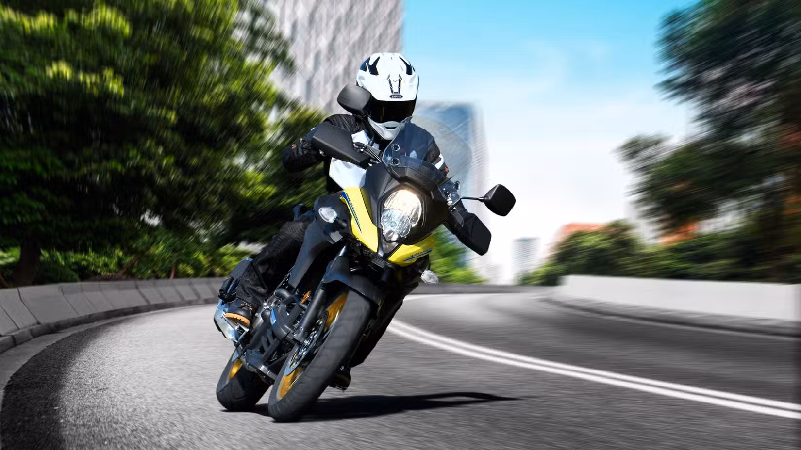 Front action shot of a yellow Suzuki V-Strom 650XT cornering at speed