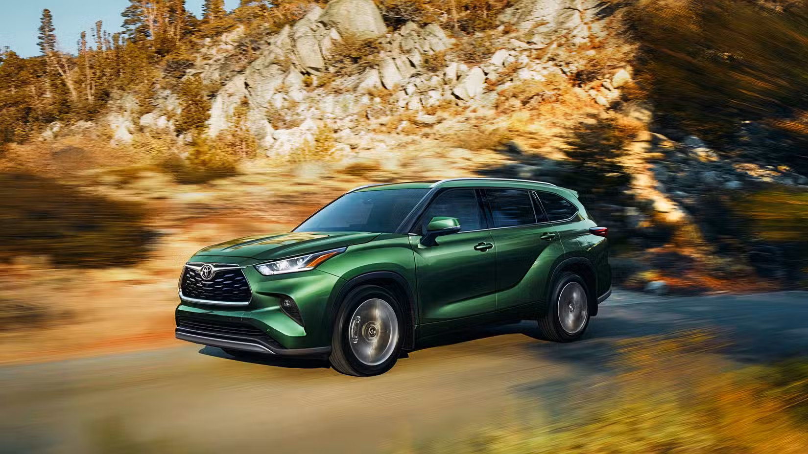 A green 2024 Toyota Highlander Hybrid. 