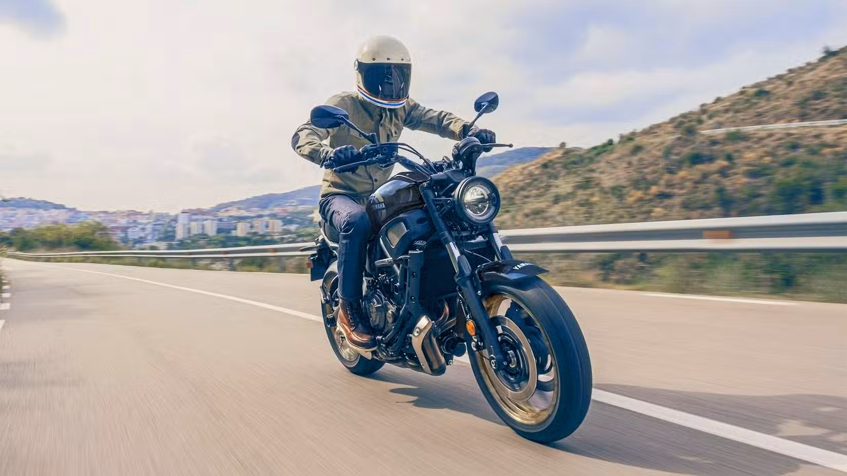 Yamah XSR700 accelerating on the road, front third quarter view