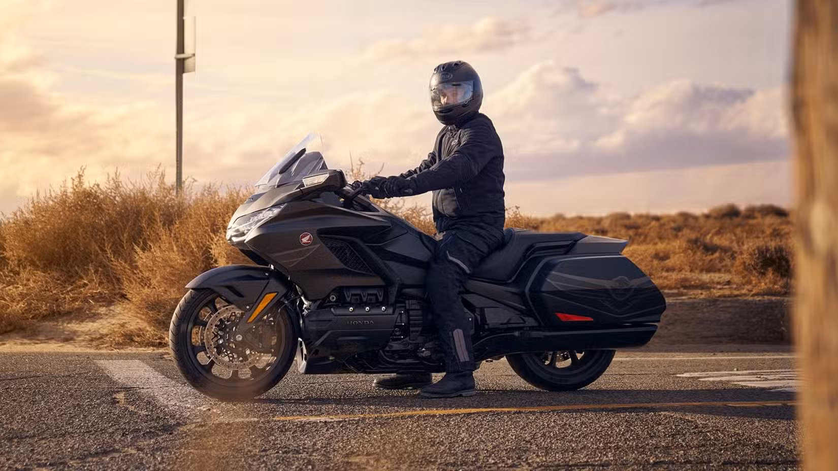 A rider straddling the 2025 Honda Gold Wing 50th Anniversary Edition