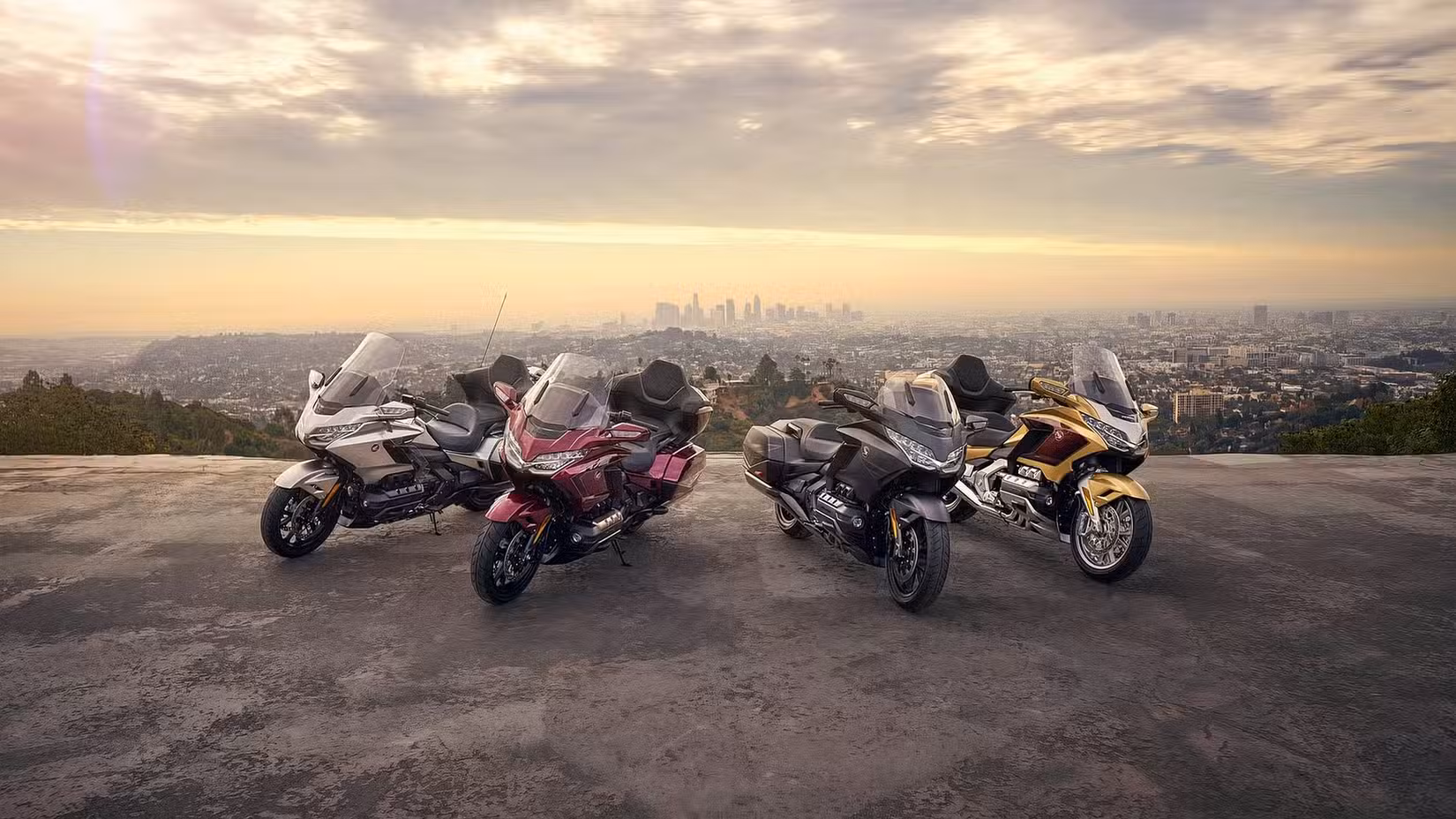 Honda Gold Wing range parked on a bluff overlooking a city