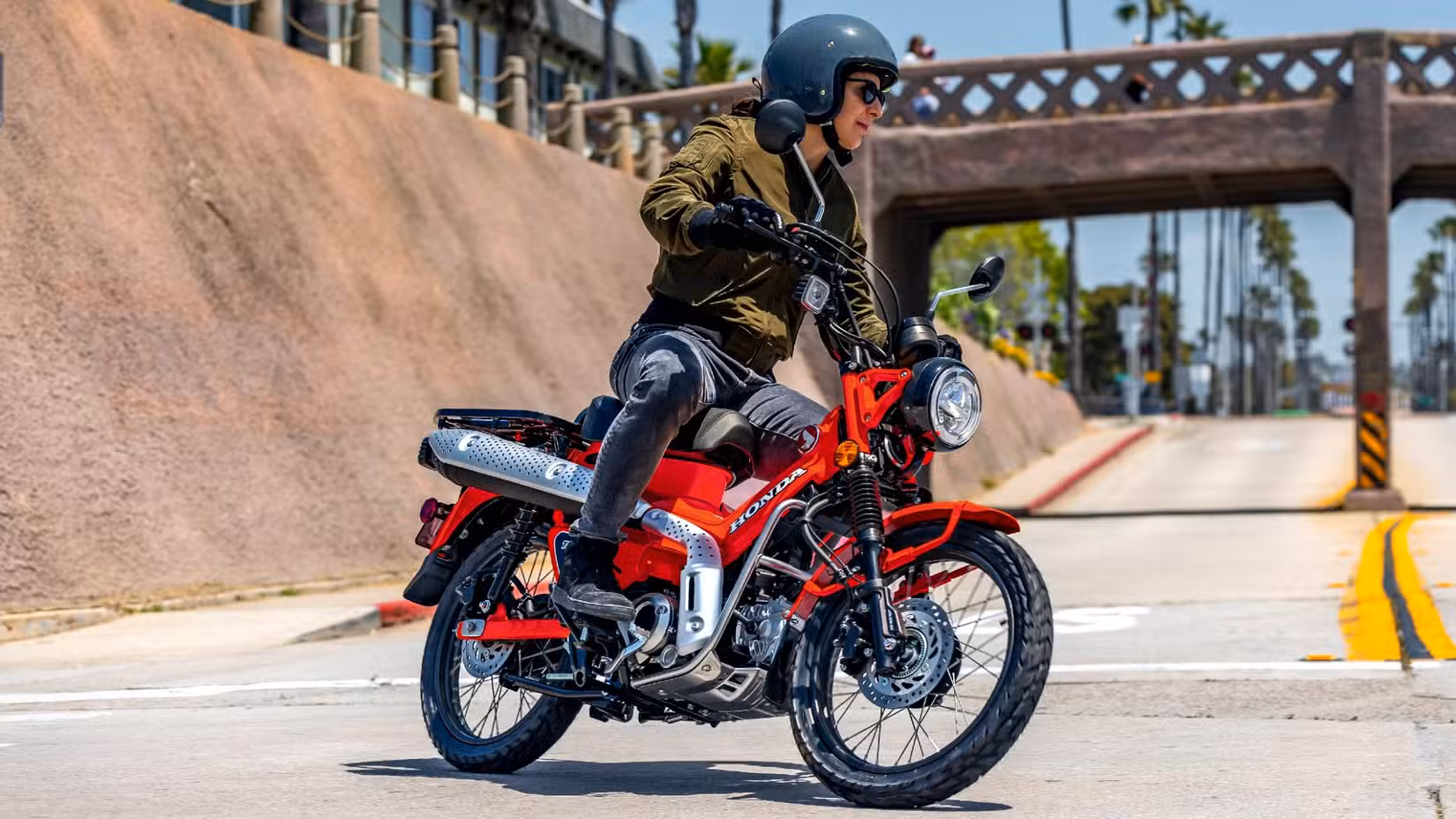 2025 Honda Trail 125 riding through an intersection