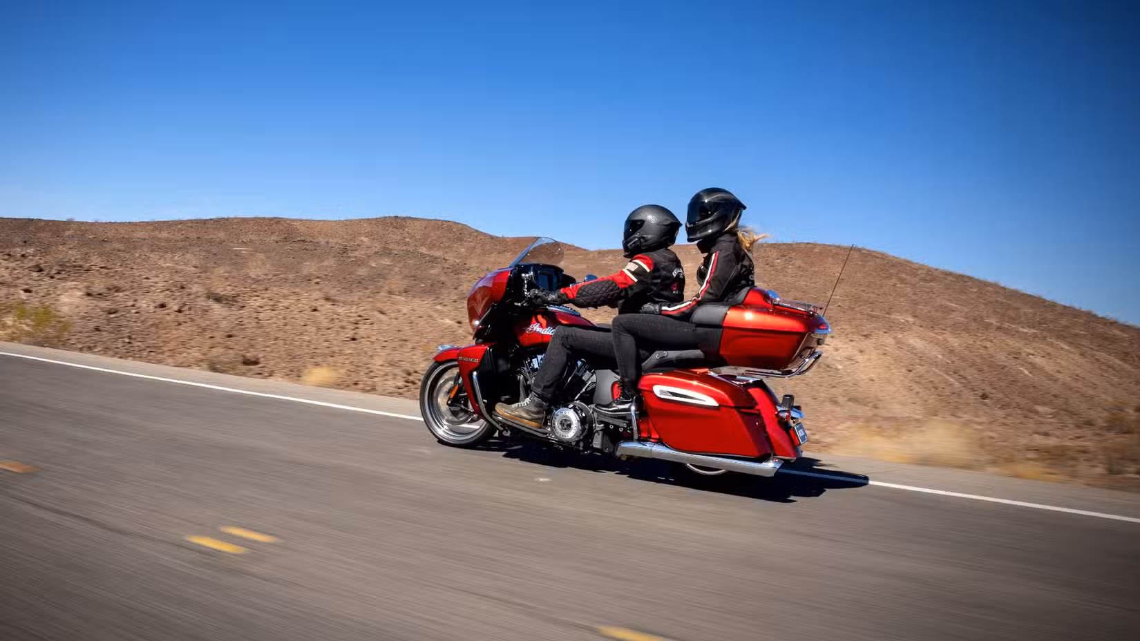 Side shot of a 2025 Indian Roadmaster PowerPlus cruising down the highway