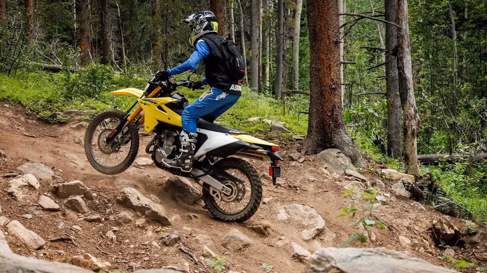 A rider off-roading on the 2025 Suzuki DR-Z4S in the forest