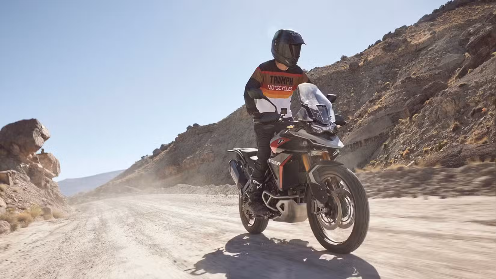 Front shot of a Triumph Tiger 900 GT on light trail