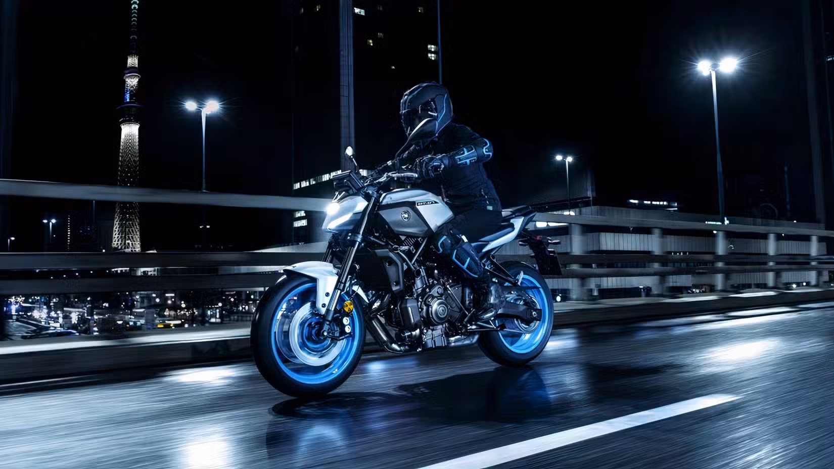 Action shot of a Yamaha MT-07 cruising on an elevated road at night