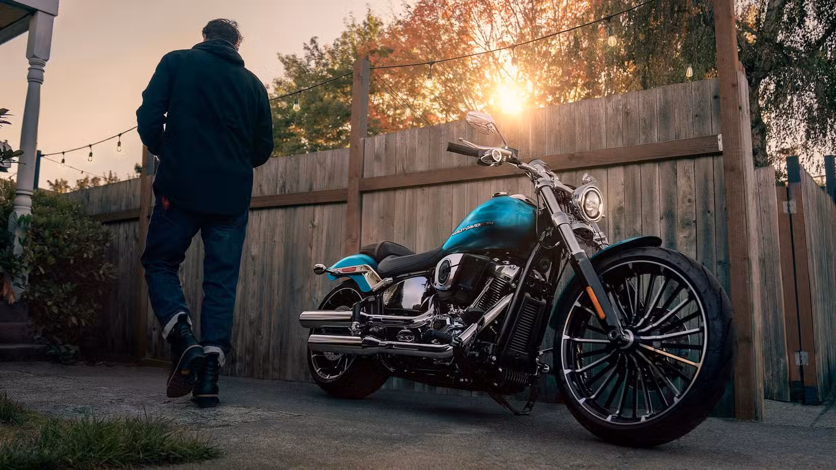 A parked Harley-Davidson Breakout with rider walking up to it