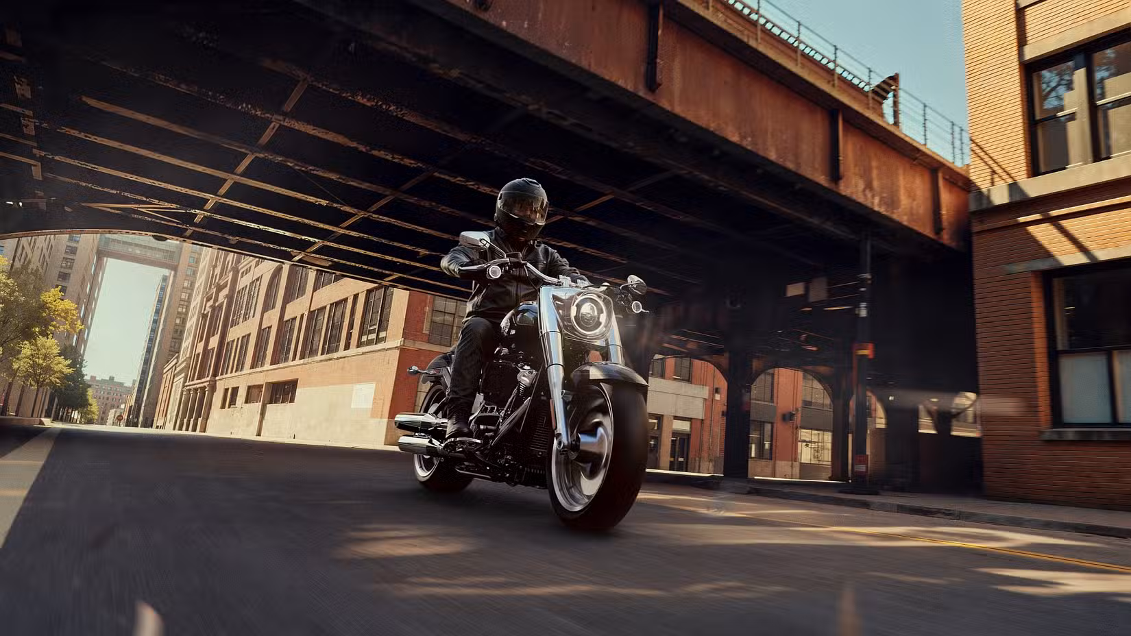 An action shot of a 2026 Harley-Davidson Fat Boy on city streets