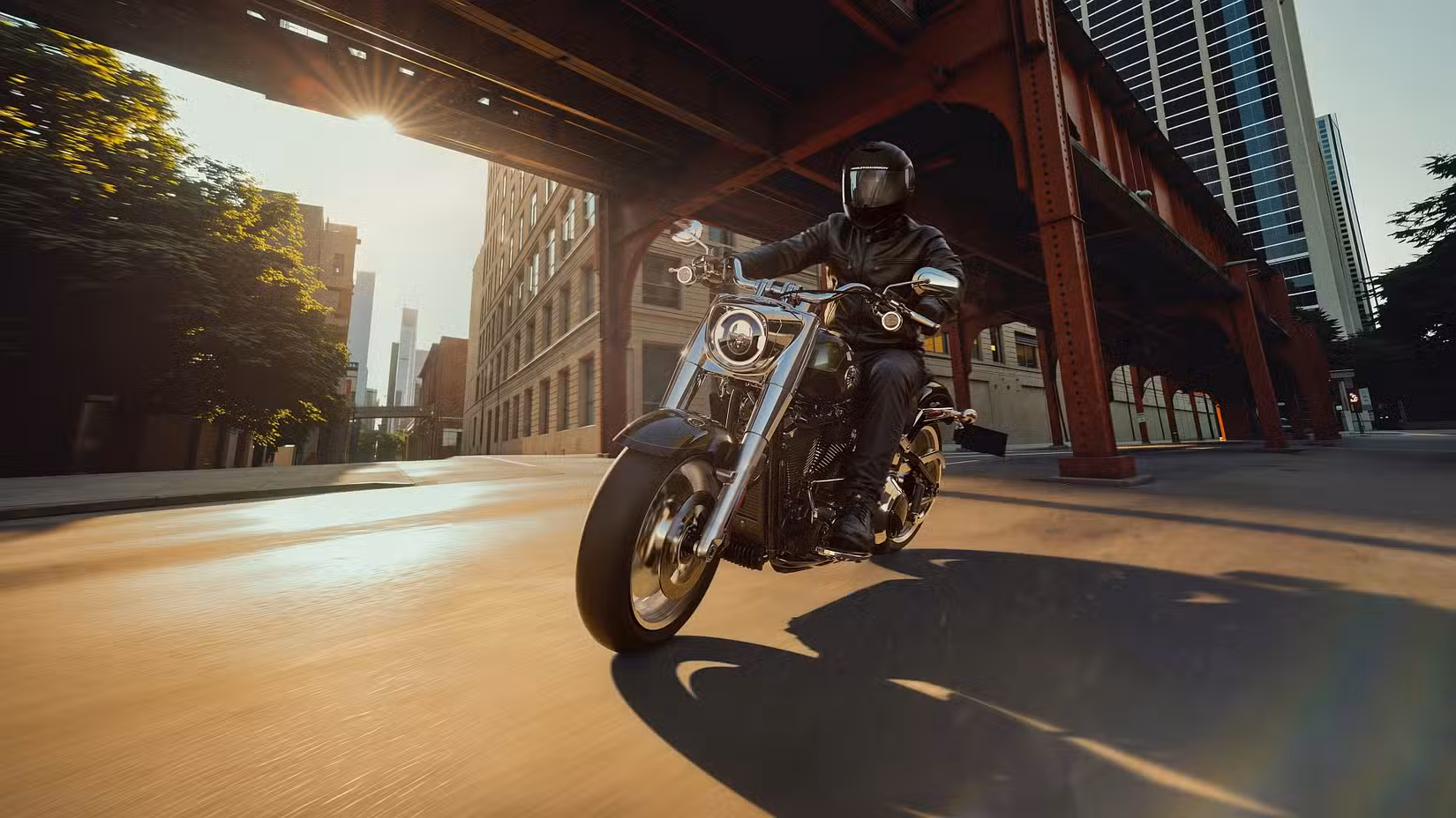 2026 Harley-Davidson Fat Boy riding under a bridge