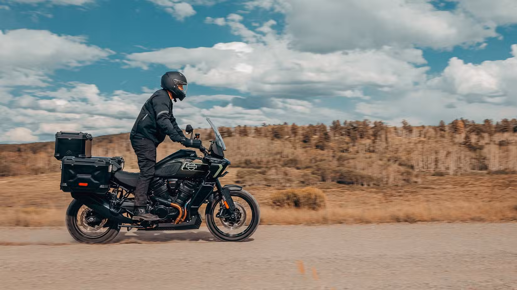 Shot of 2026 Harley-Davidson Pan America 1250 Limited with rider standing on a dirt road