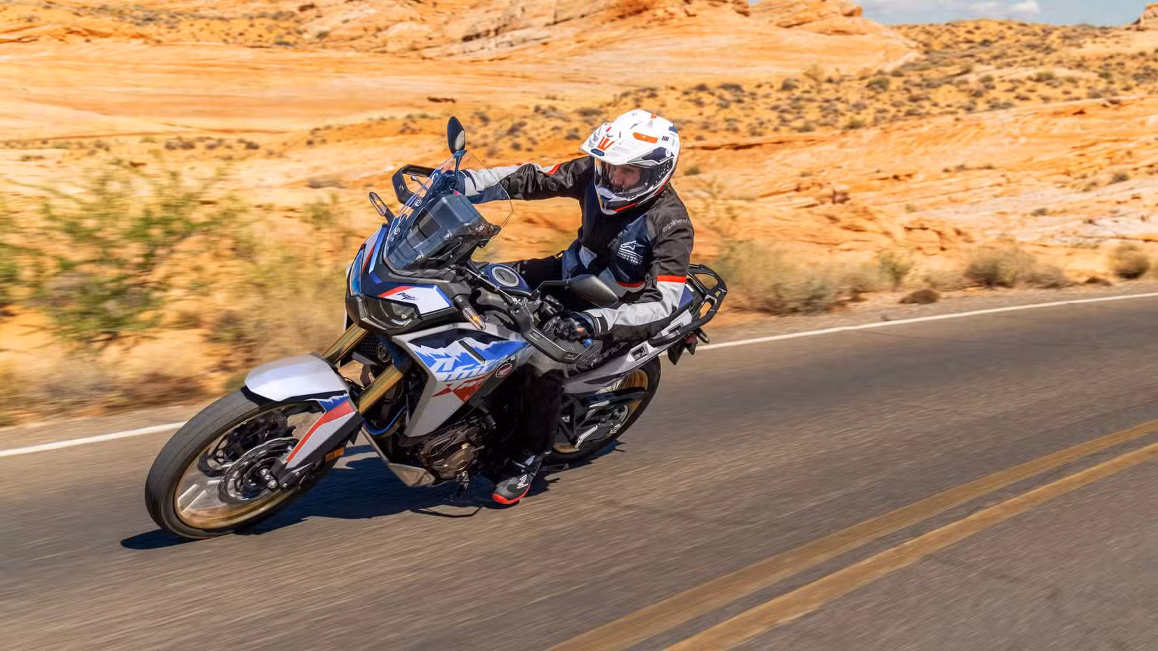 A tracking shot of a Honda Africa Twin Adventure Sports ES leaning into a corner