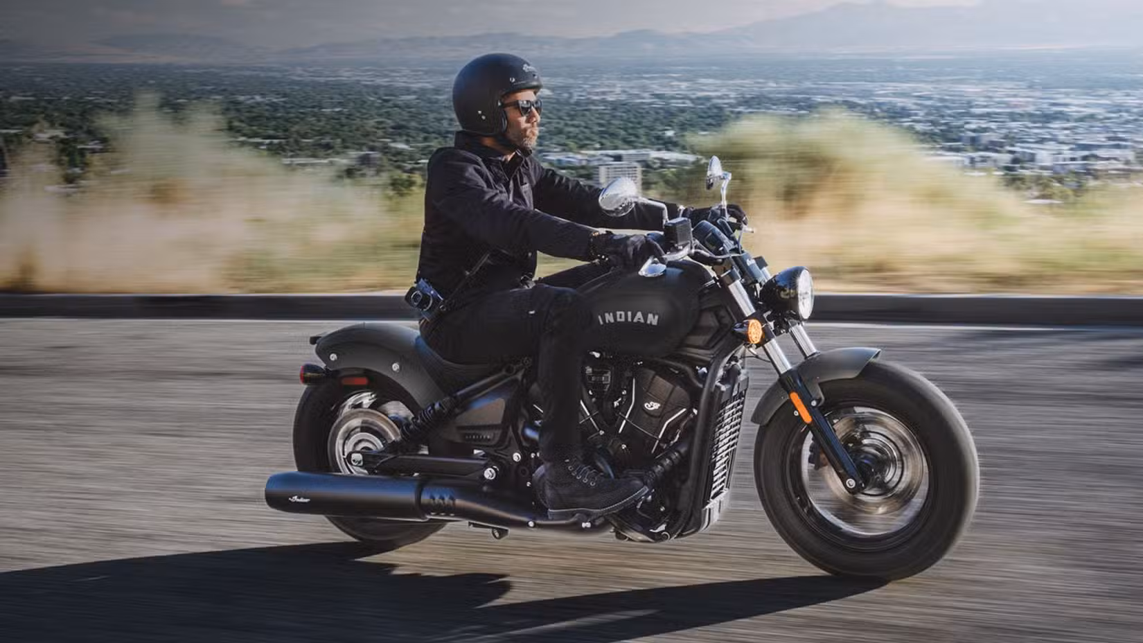 Action shot of the 2026 Indian Scout Sixty Bobber cruising. 