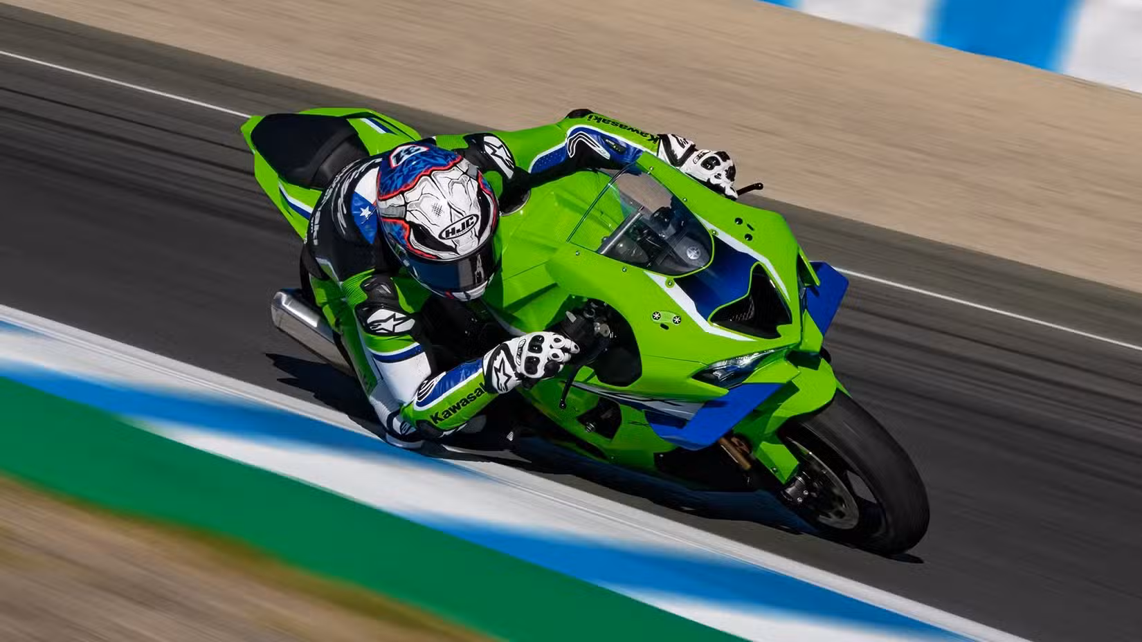 Rider cornering hard with a Kawasaki Ninja ZX-10R on the race track