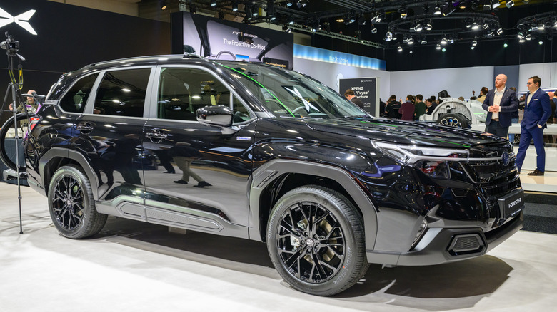 A dark colored Subaru Forester on display at a motor show