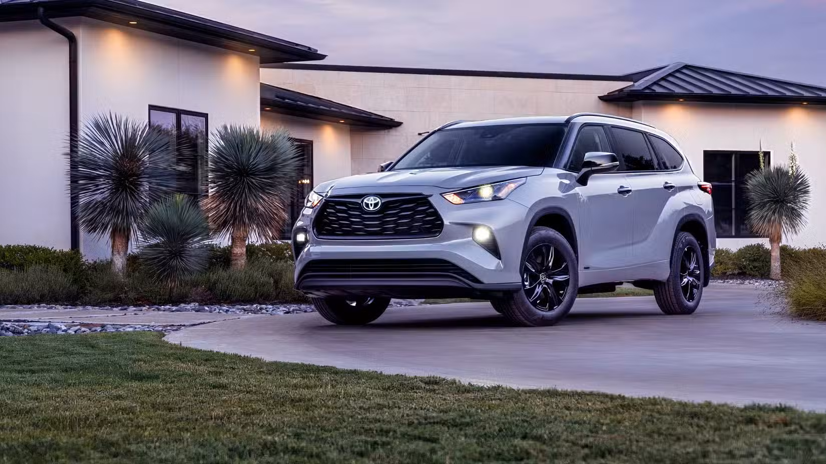 2026 Toyota Highlander Hybrid Front 3/4 shot parked in driveway