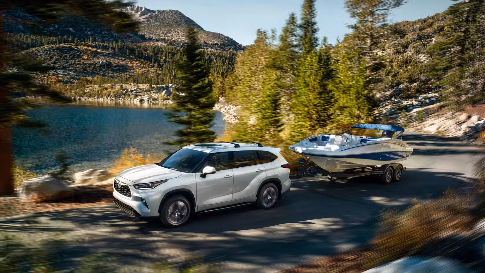 2026 Toyota Highlander Hybrid side shot Pulling A Boat