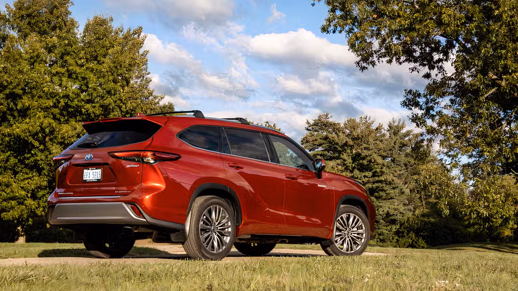 2026 Toyota Highlander Hybrid Rear 3/4 shot parked in grass