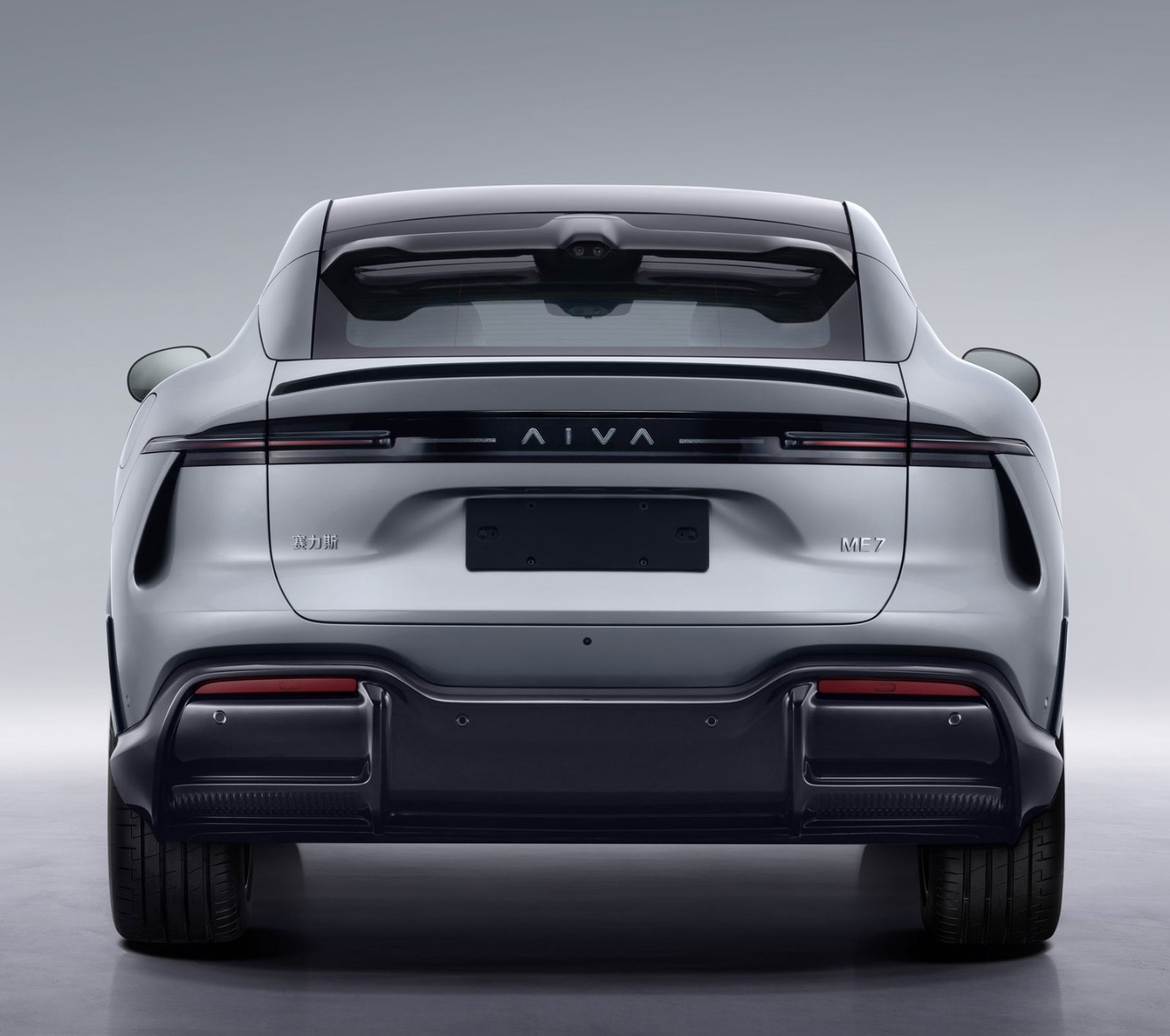 Rear view of the silver Aiva ME7, showing slim taillights, a roof spoiler and Aiva, ME7 and Seres badges.