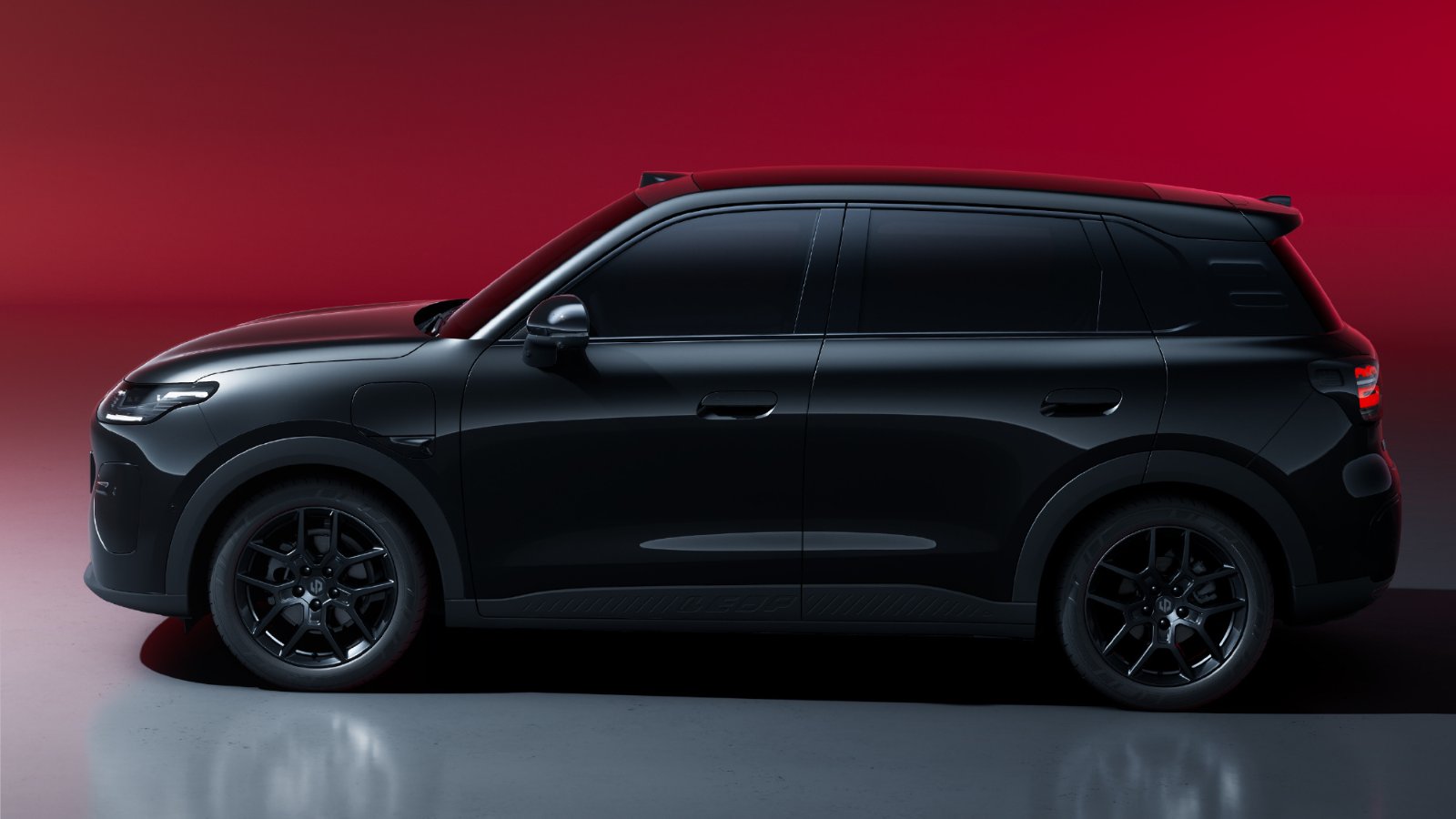 Side profile of the Leapmotor A10s, showing its black paint, black alloy wheels and rear roof spoiler.