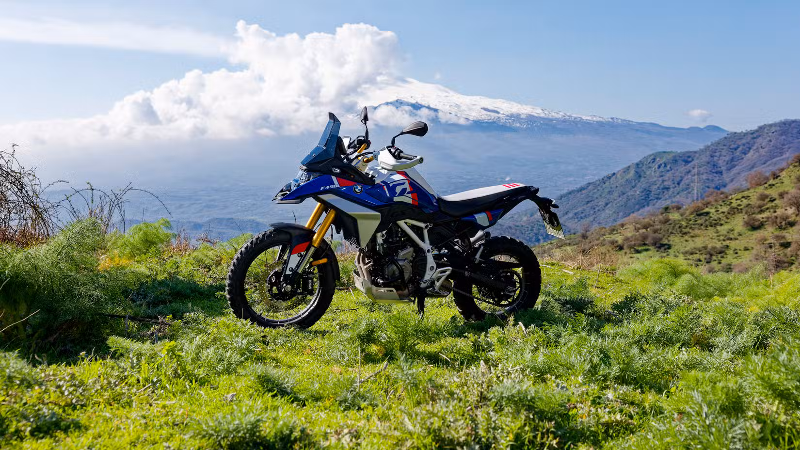 A cinematic shot of the 2027 BMW F 450 GS Trophy atop a mountain
