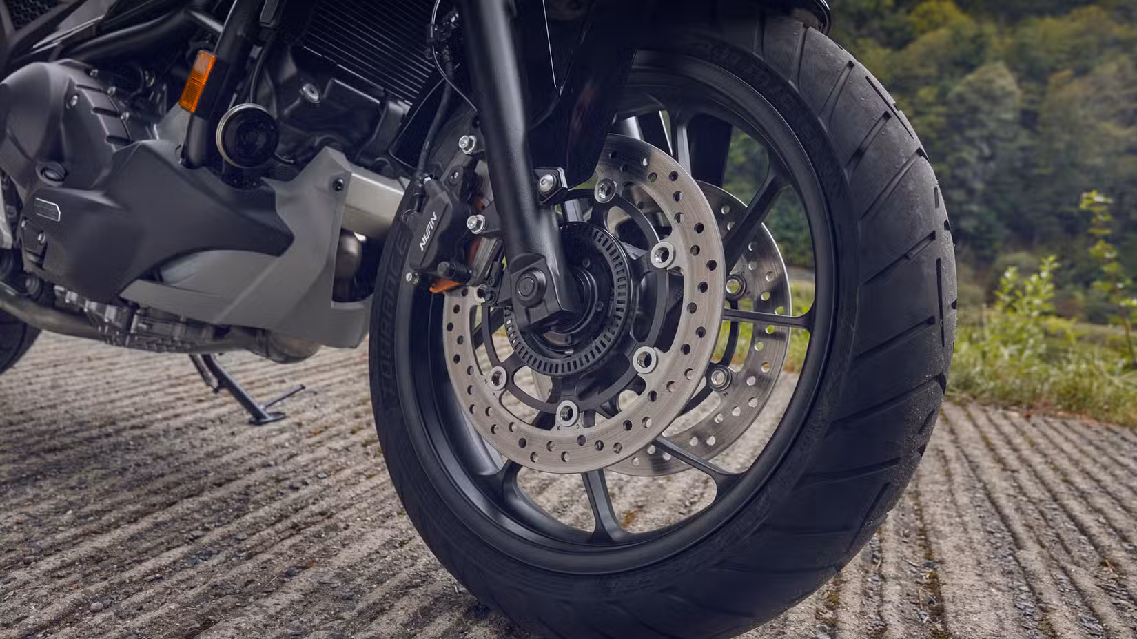 2027 Honda NC750X DCT close-up shot of the front brakes
