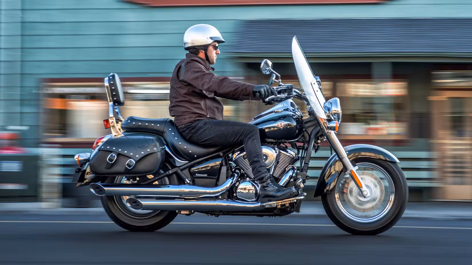 Rider on a 2027 Kawasaki Vulcan 900 Classic LT crusiing through town