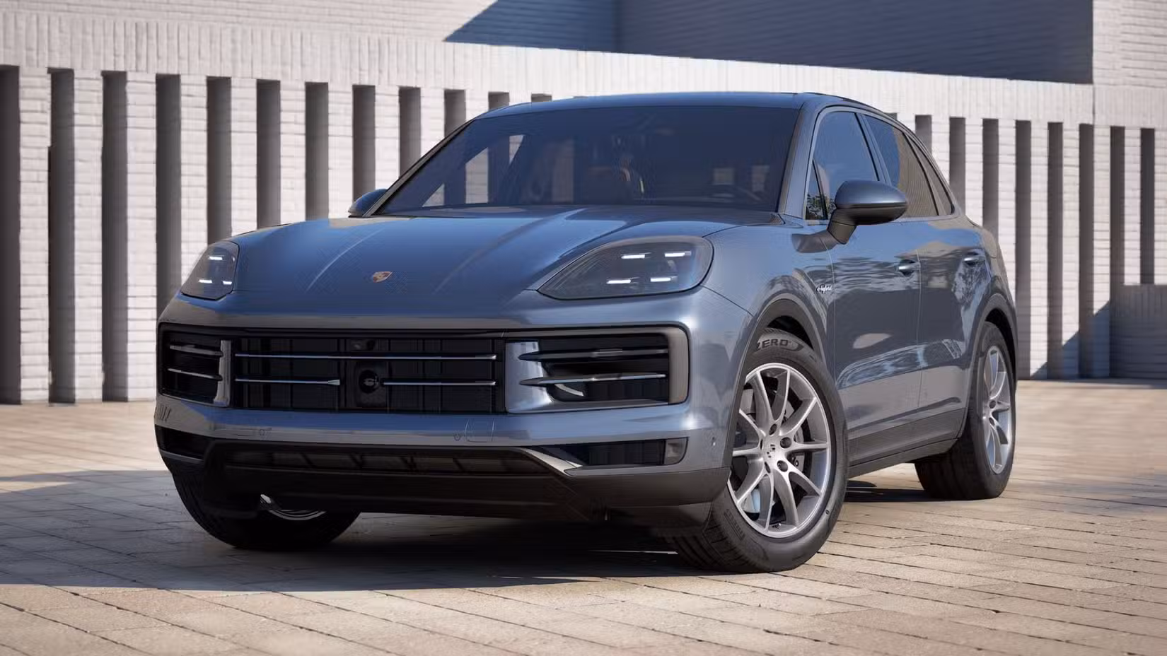 The front 3/4 view of a grey 2027 Porsche Cayenne E-Hybrid.
