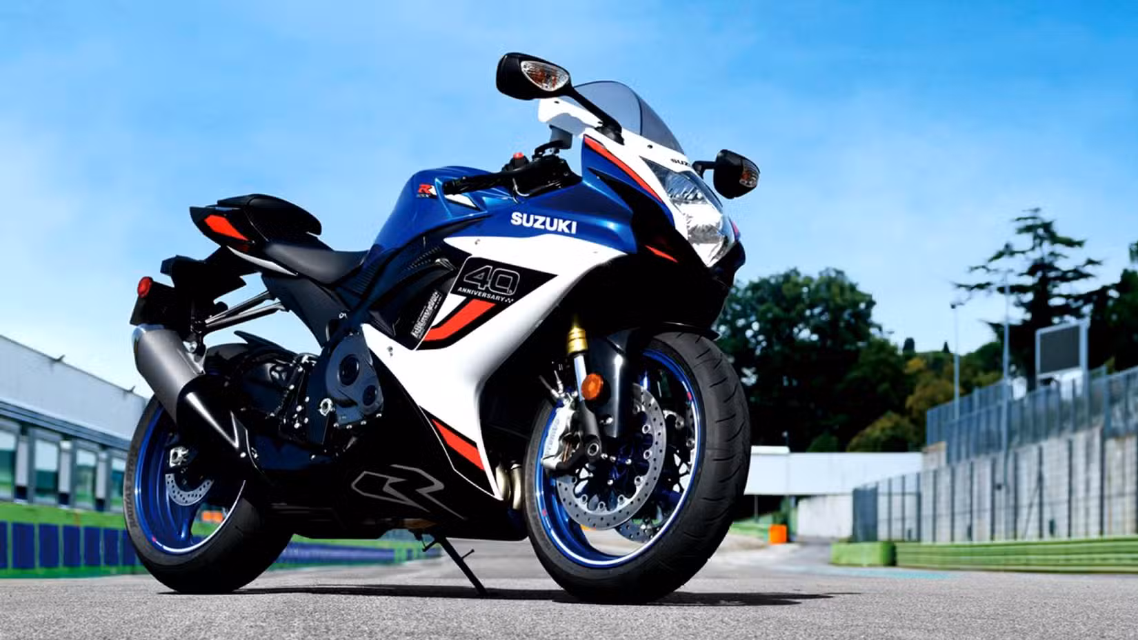 Front 3/4 shot of a 2027 Suzuki GSX-R750 40th Anniversary Parked On A Racetrack