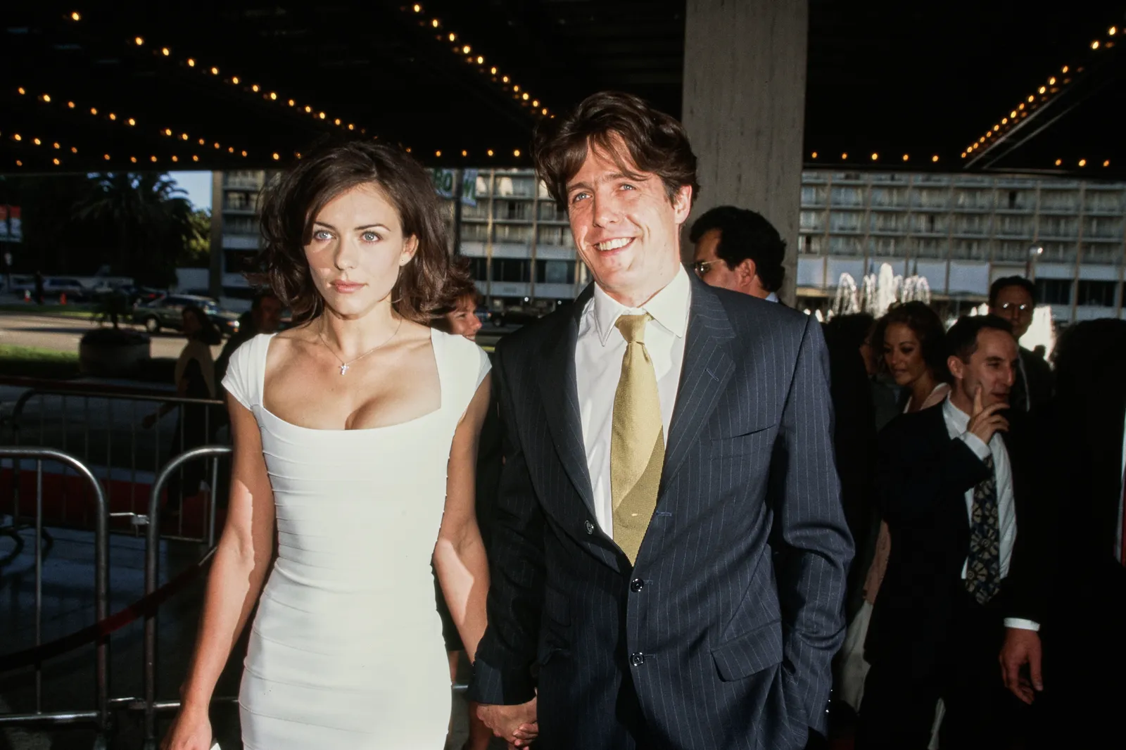 Image may contain Hugh Grant Elizabeth Hurley Peter Chernin Candy Crowley Blazer Clothing Coat and Jacket