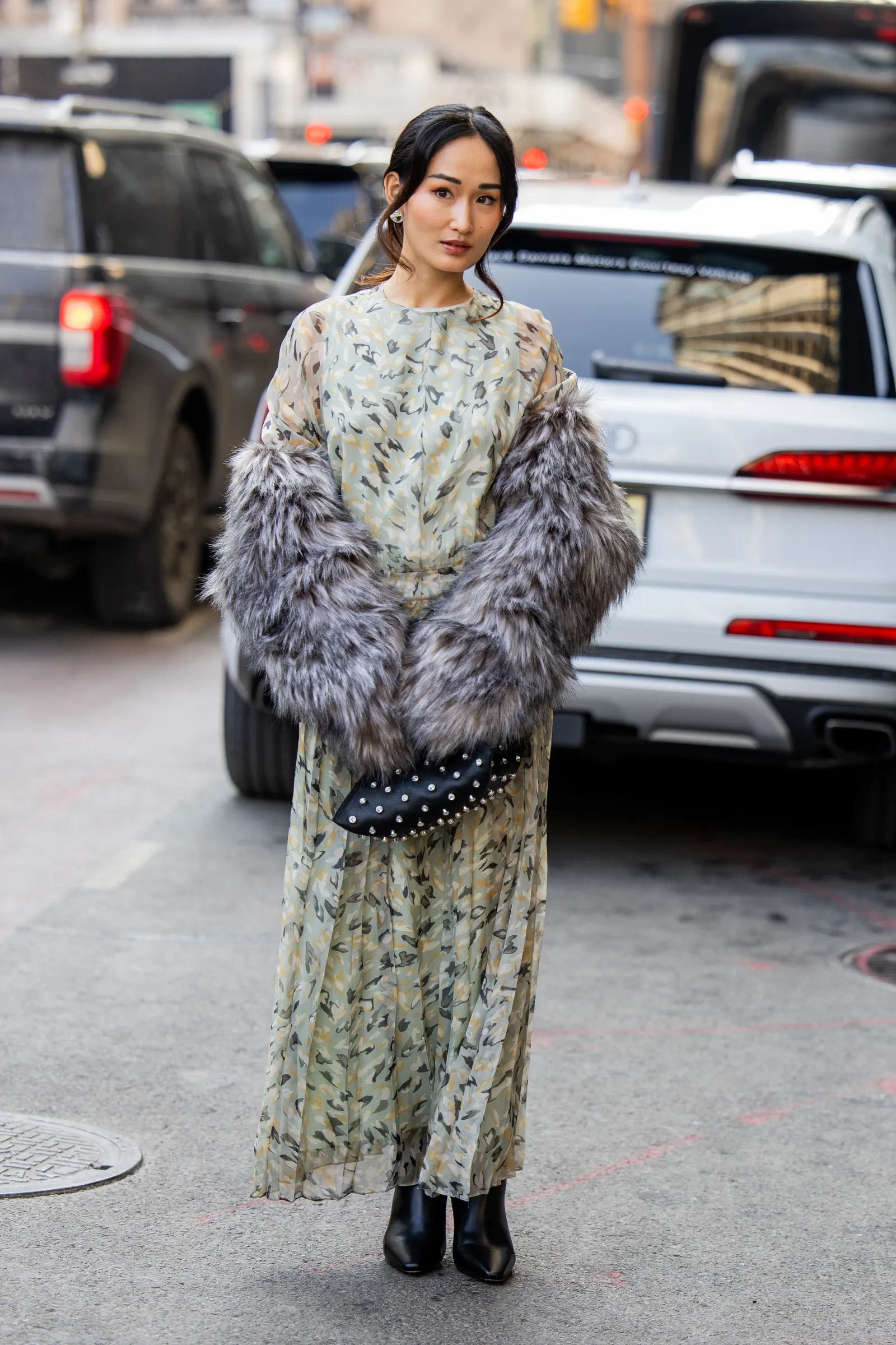 NEW YORK NEW YORK  FEBRUARY 14 A guest wears dress with fur sleeves black bag outside Altuzarra on February 14 2026 in...