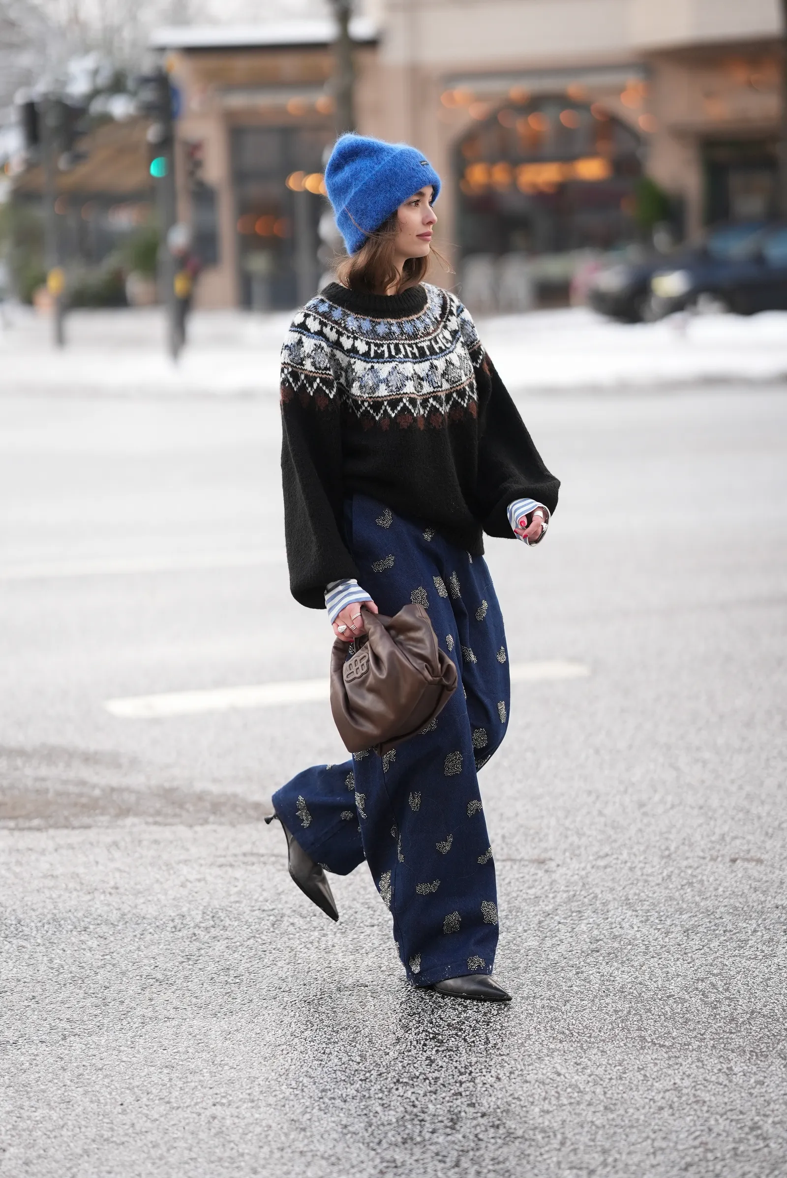 Image may contain Sarah Stephens Clothing Pants Person Pedestrian Cap Hat Knitwear Sweater and Walking
